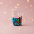 Assortiment HITSCHIES 100g fond rose bokeh